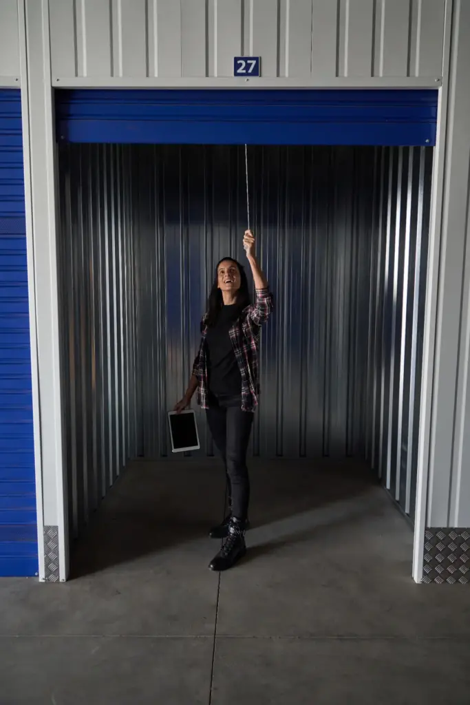 Woman closing up her self storage unit