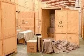 Self-storage unit filled with furniture and boxes, showcasing organization and space